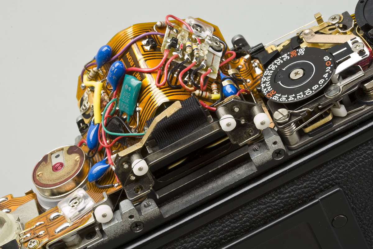 Again, be careful of the tungsten wire when removing viewfinder. A burst of compressed air is usually all that is needed to clean dust from pentaprism.