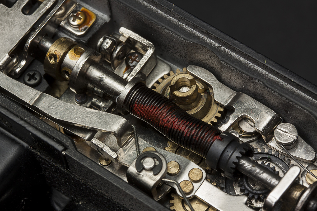 The swipe contacts on the AT selector dial have broken off on this camera, rendering this camera useless. To replace the dial, remove these two screws.